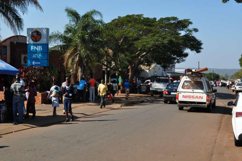 A row of shops and banks lines the main road through the village